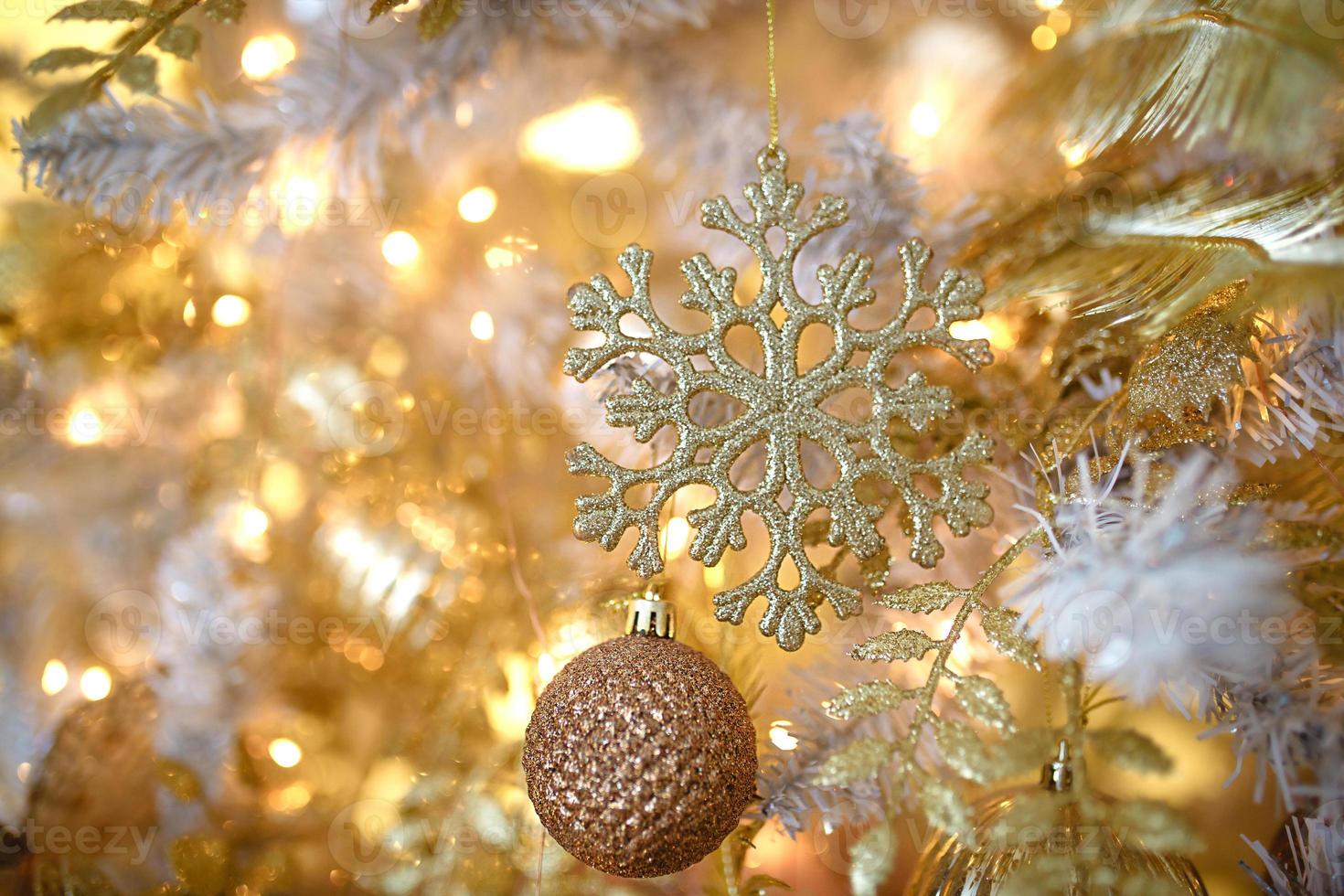 Christmas decorations on a fir tree close-up. Toys, cones, garlands with lights, balls, beads. New year, festive background. photo