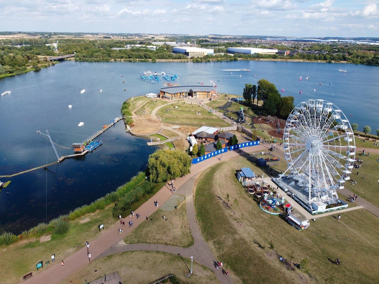 Beautiful Aerial Drone's Camera  Footage of Willen Lake and Park which is located at Milton Keynes, England. People are Enjoying at Lake on a Hot Sunny Day of Summer. Video Clip Captured on 21-8-2022 photo