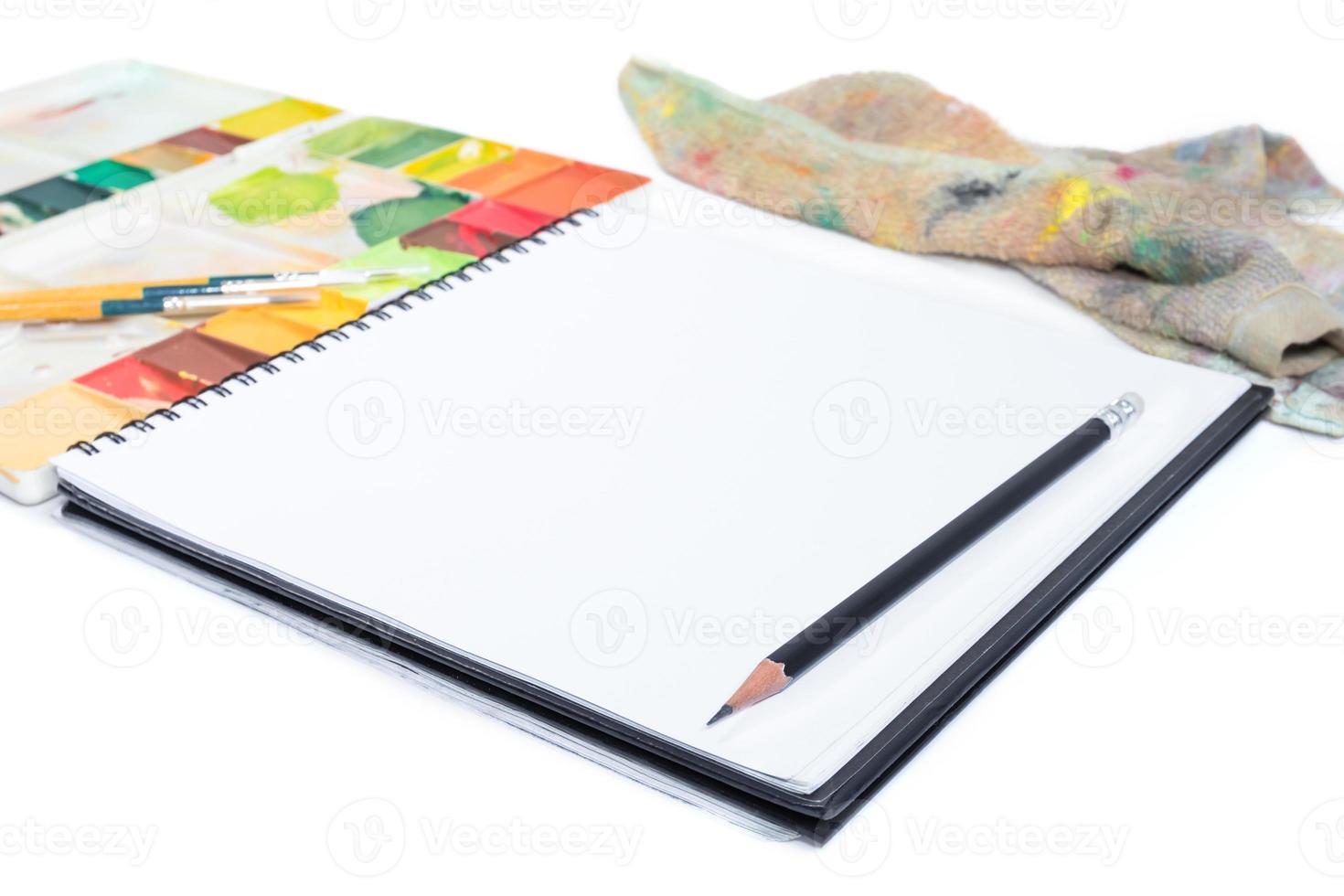 closeup open note book with tray colors on background photo