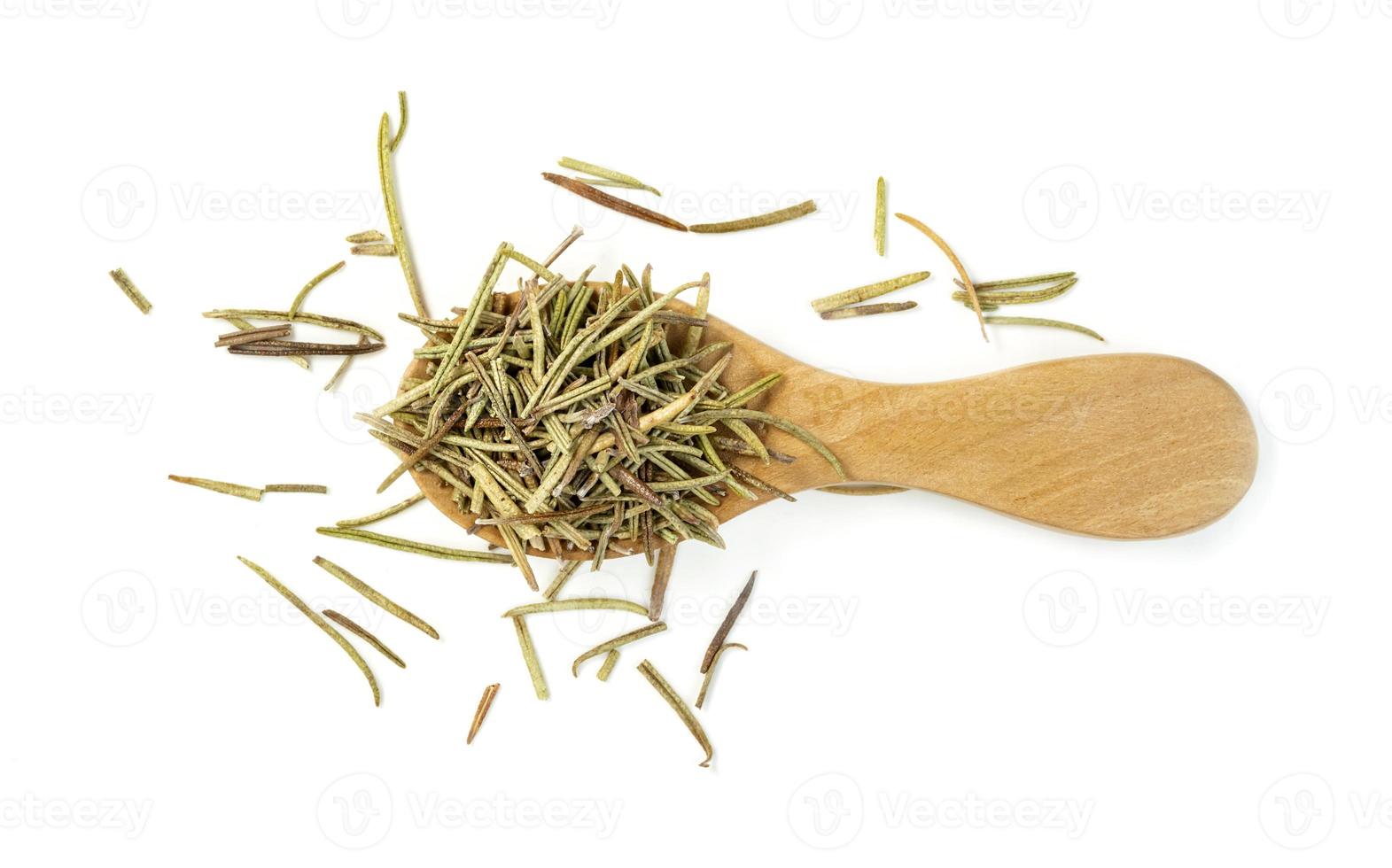 Dry rosemary in wooden spoon isolated on white background photo