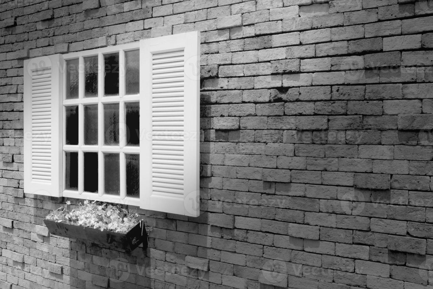 black and white wooden window on brick wall background photo