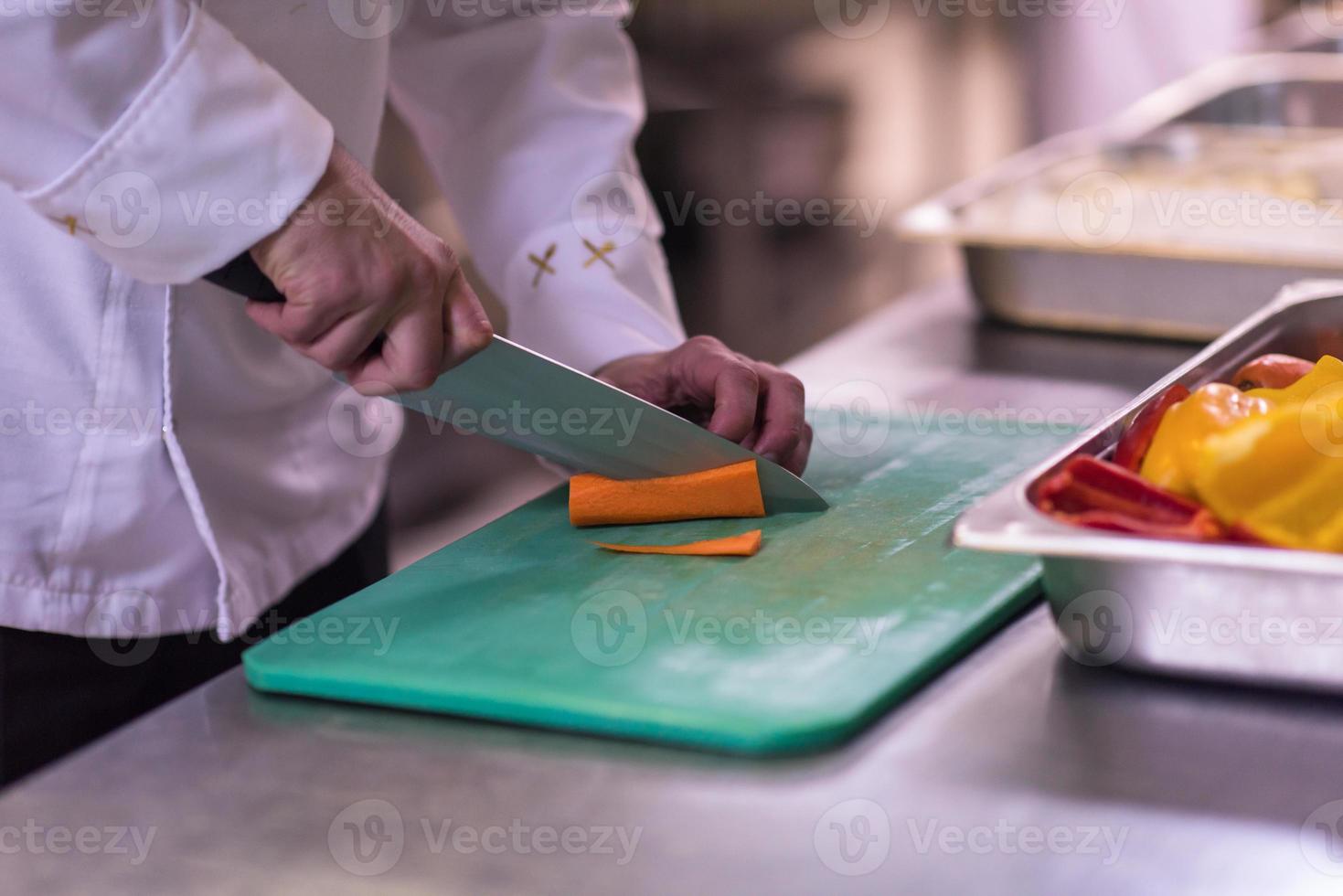 Chef hands cutting fresh and delicious vegetables photo