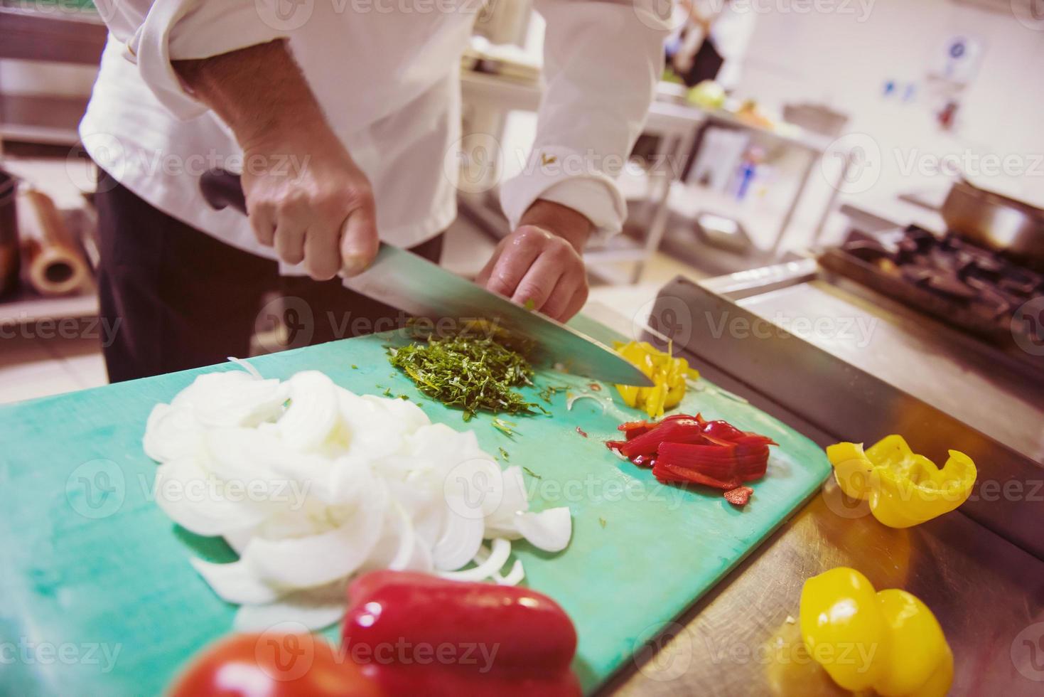 Chef hands cutting fresh and delicious vegetables photo