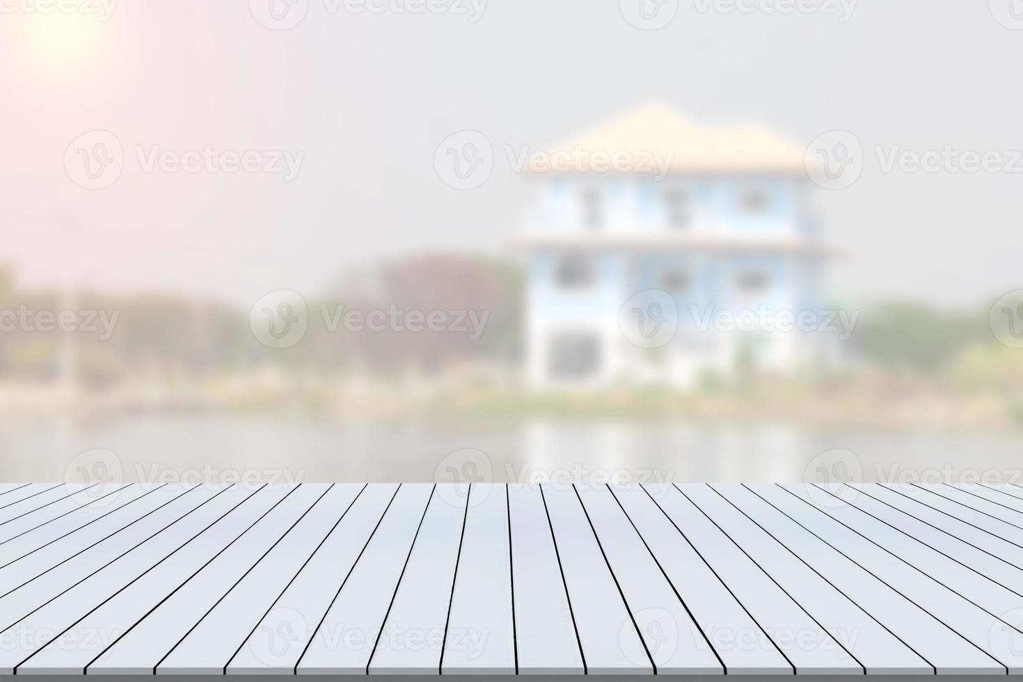 Wooden table with blur building background photo