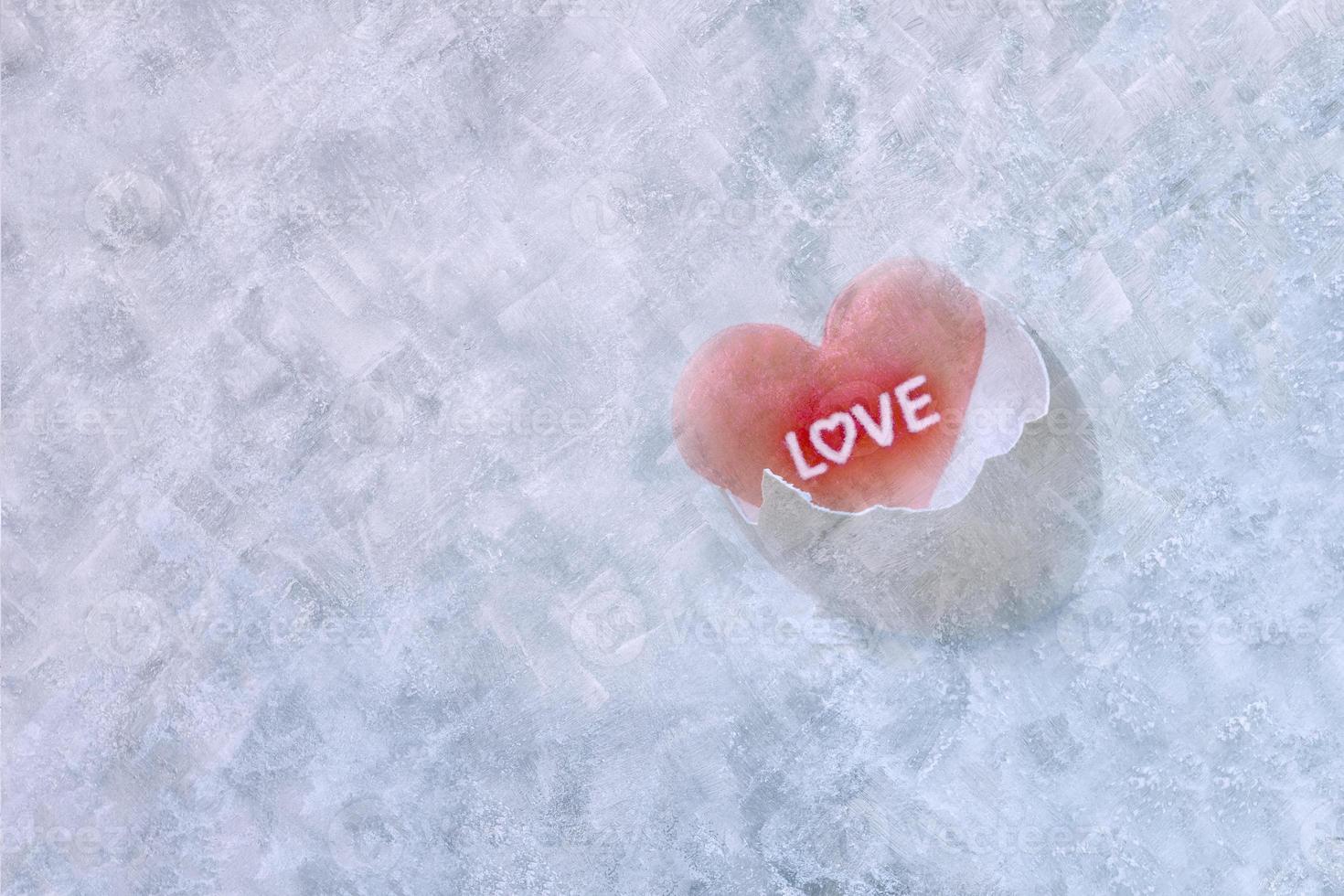 heart-shaped with broken egg on ice background photo