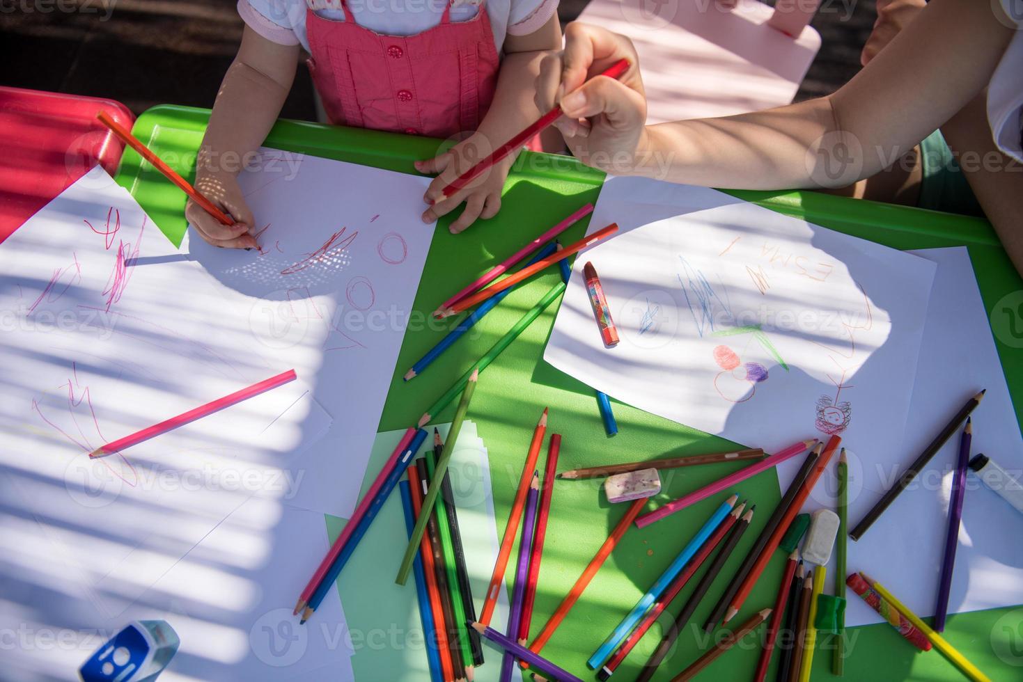 mom and little daughter drawing a colorful pictures photo