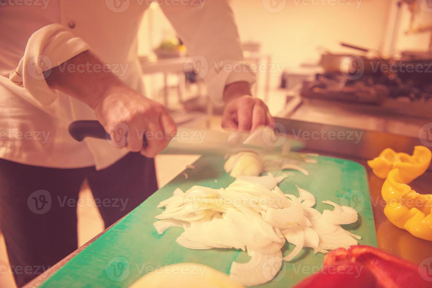 Chef hands cutting fresh and delicious vegetables photo