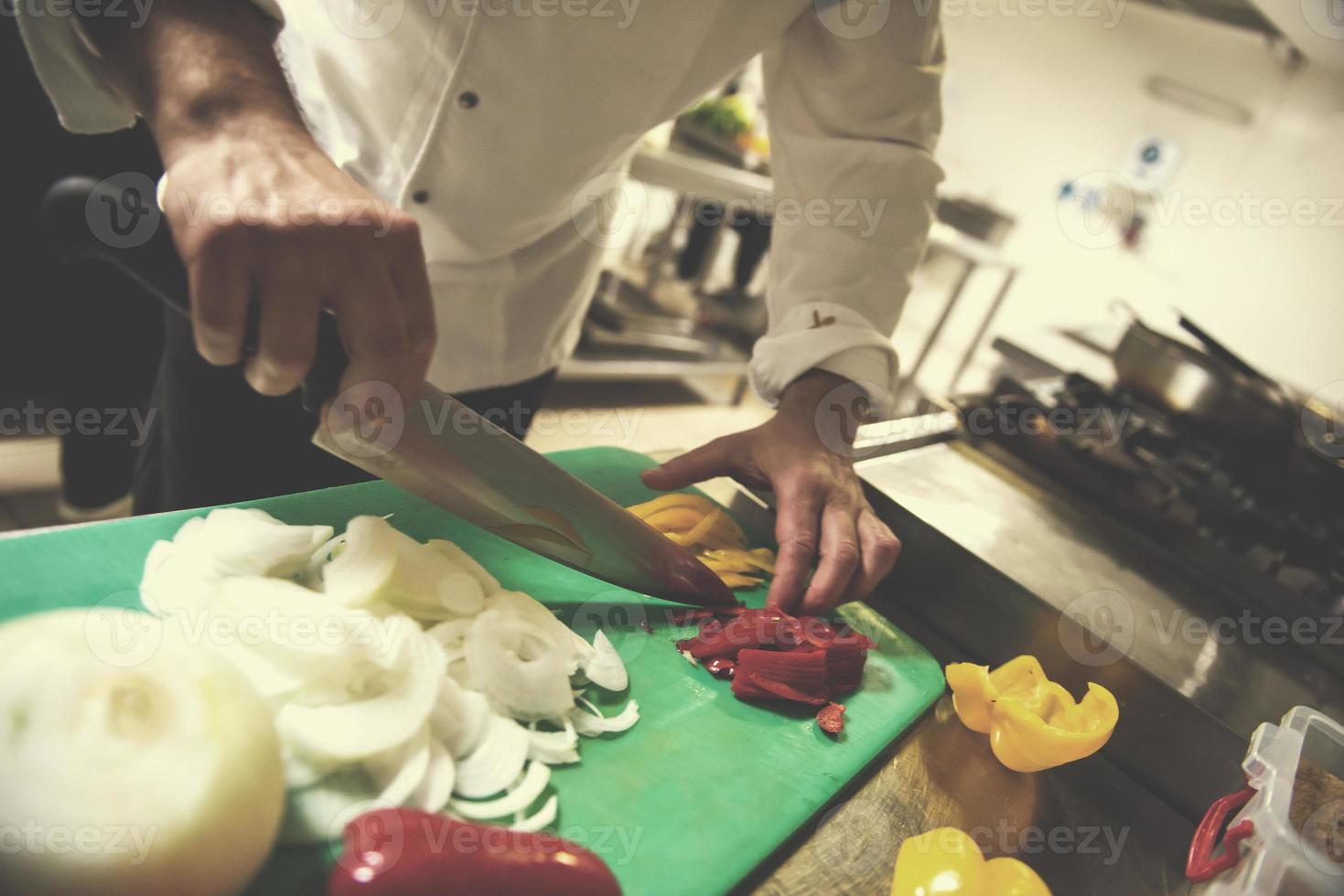 Chef hands cutting fresh and delicious vegetables photo