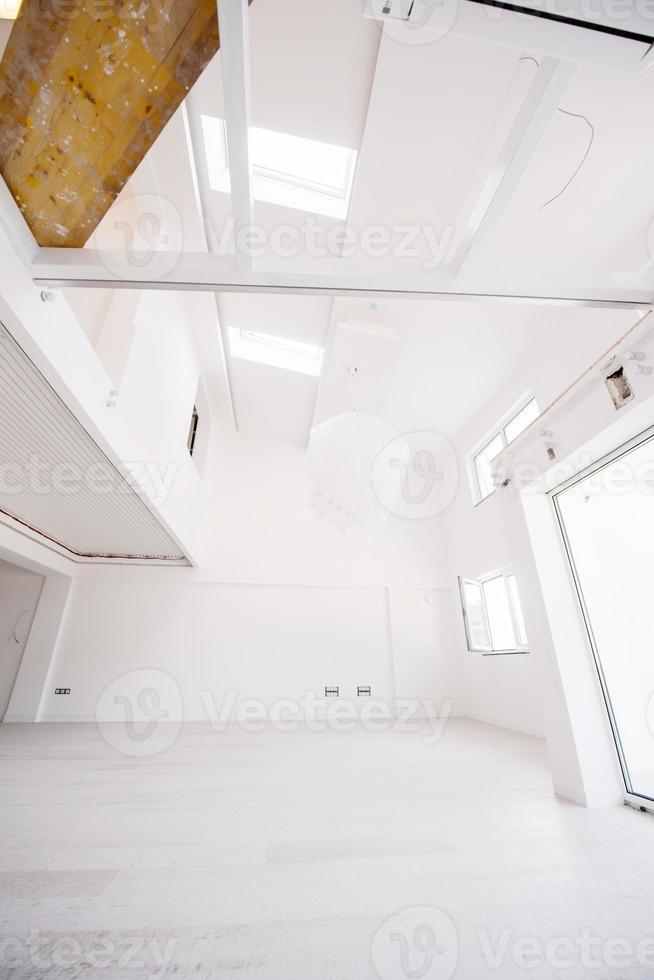 Interior of empty stylish modern open space two level apartment photo