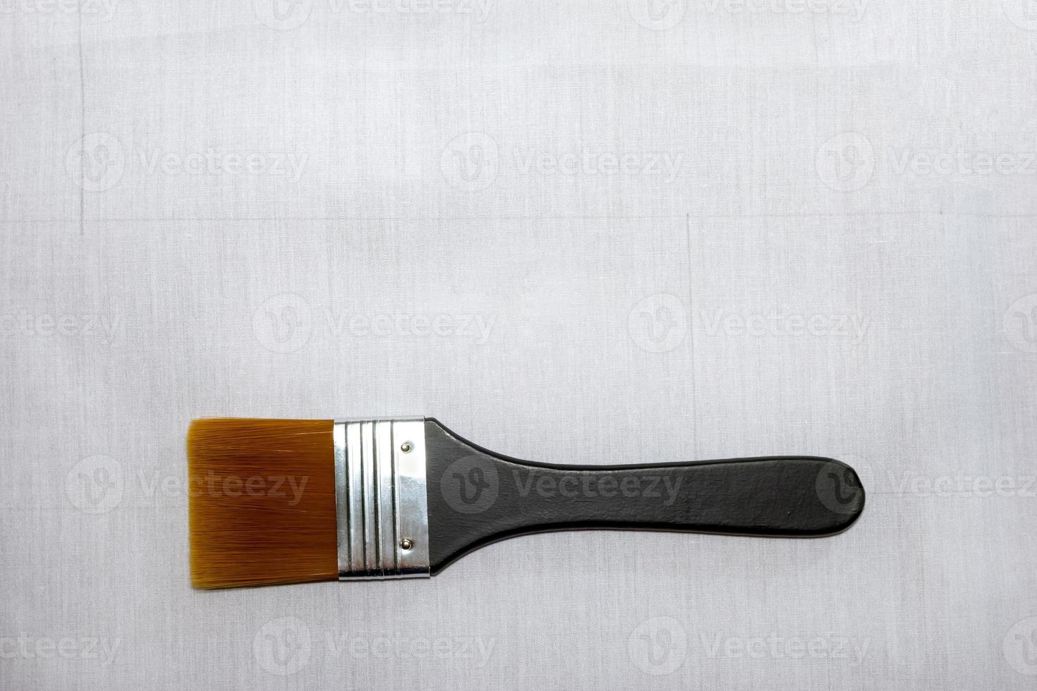 Paint brush on gray cloth photo