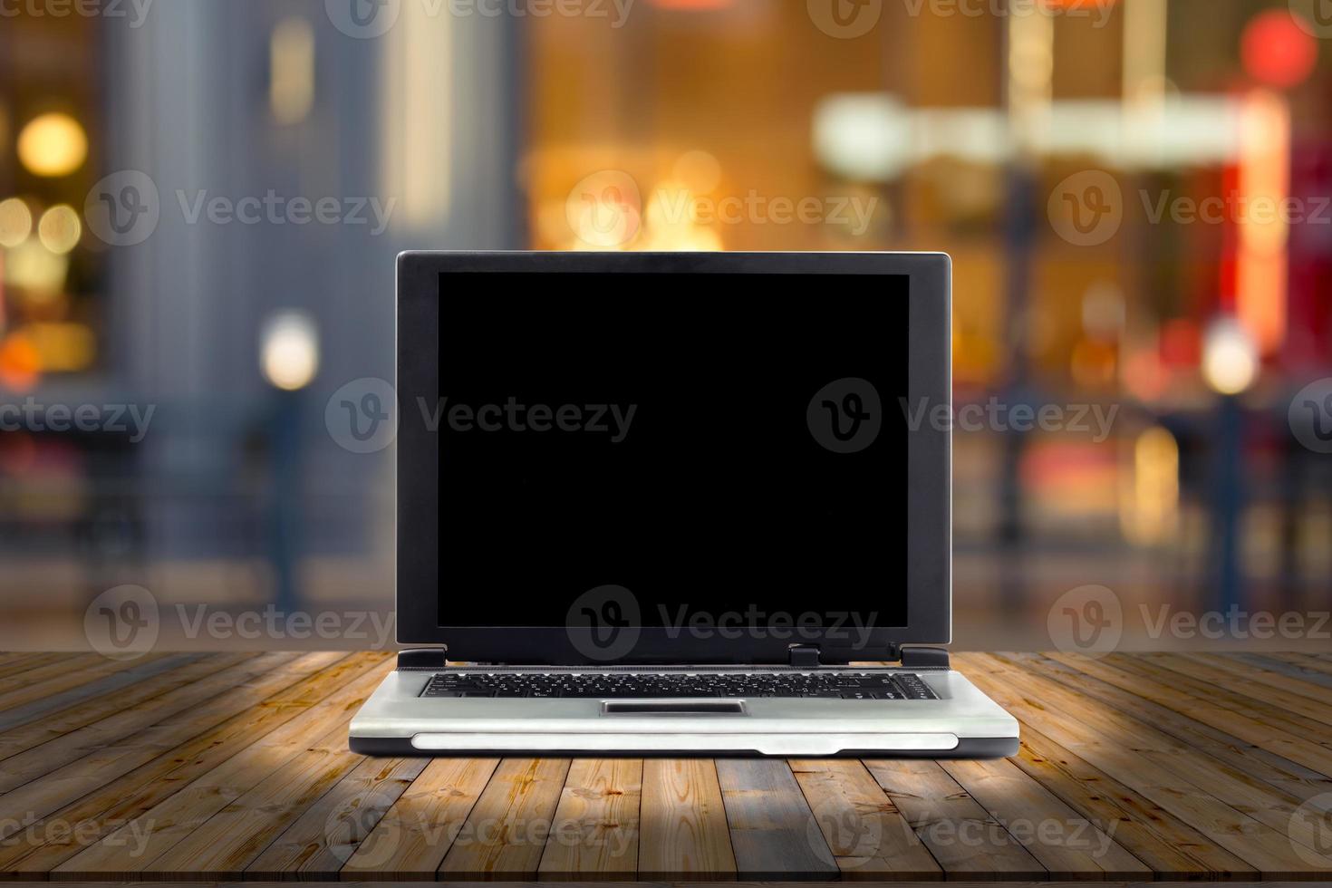 laptops on desk with blur restaurant background,top wooden table photo