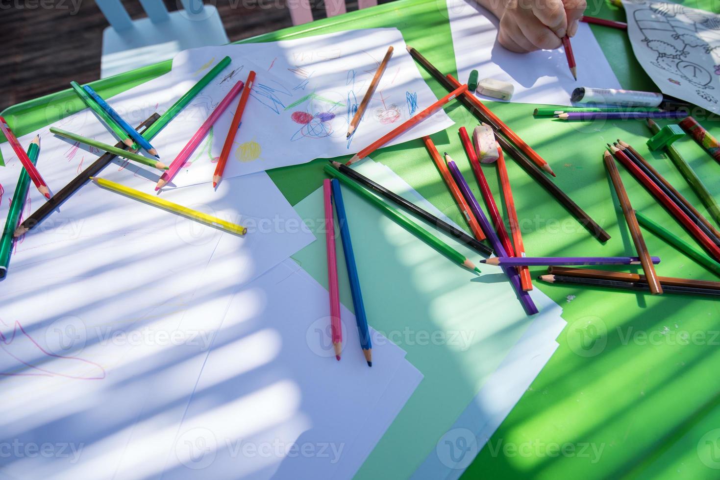 closeup of hands drawing a colorful pictures photo