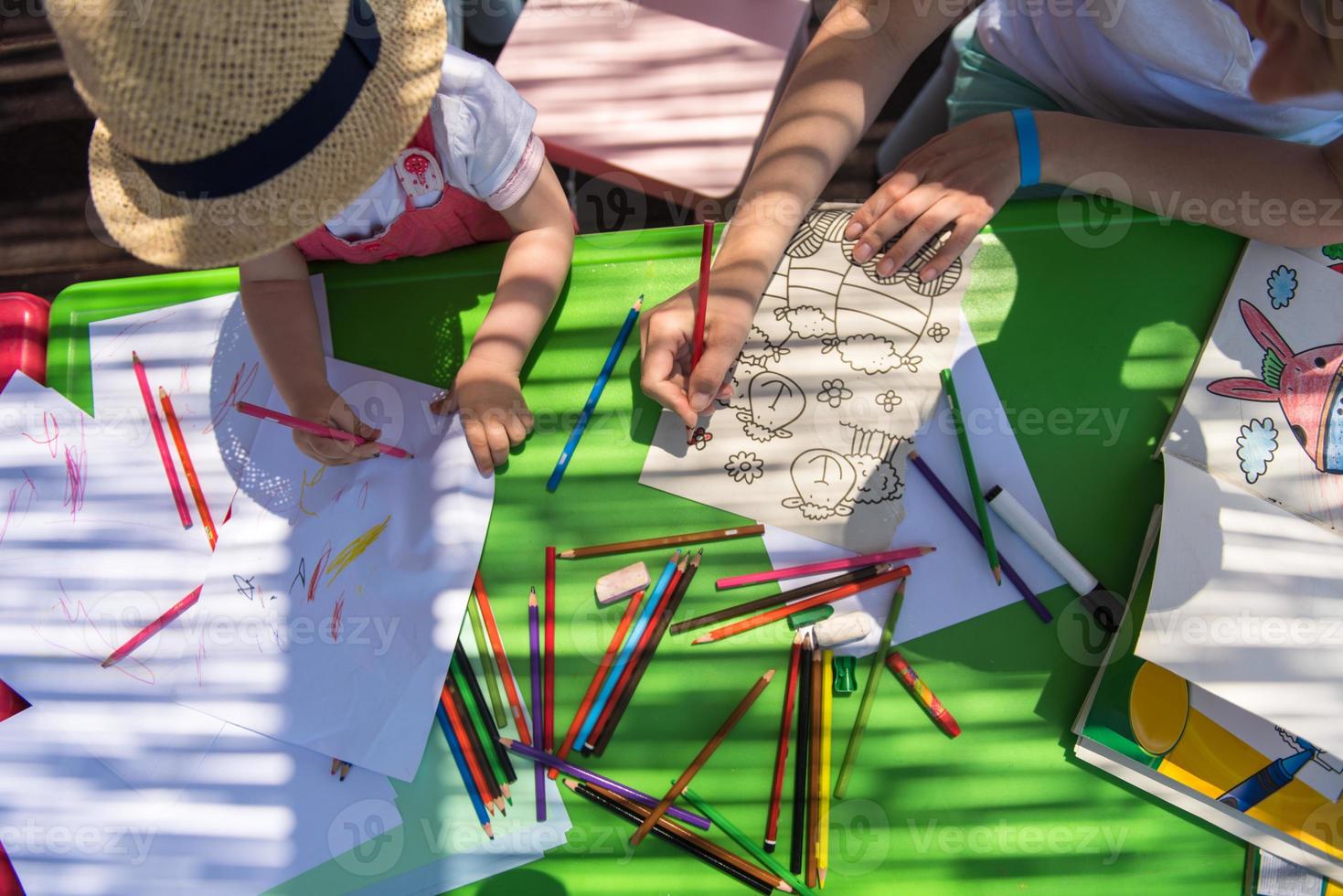 mom and little daughter drawing a colorful pictures photo