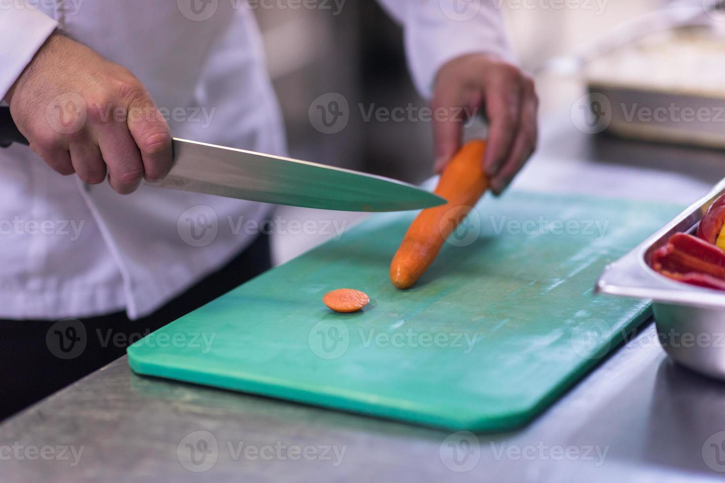 Chef hands cutting fresh and delicious vegetables photo