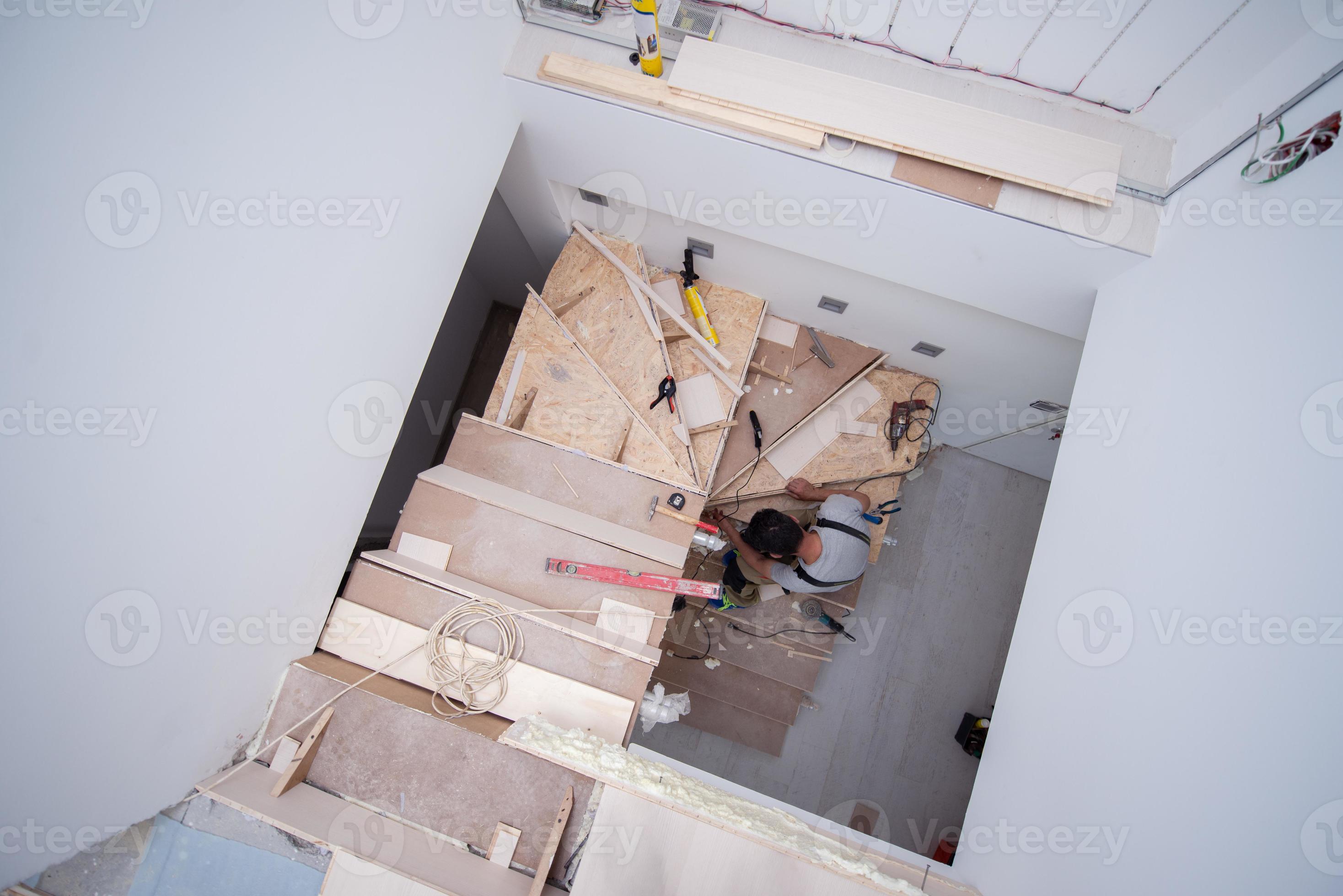carpenter installing wooden stairs 10735935 Stock Photo at Vecteezy