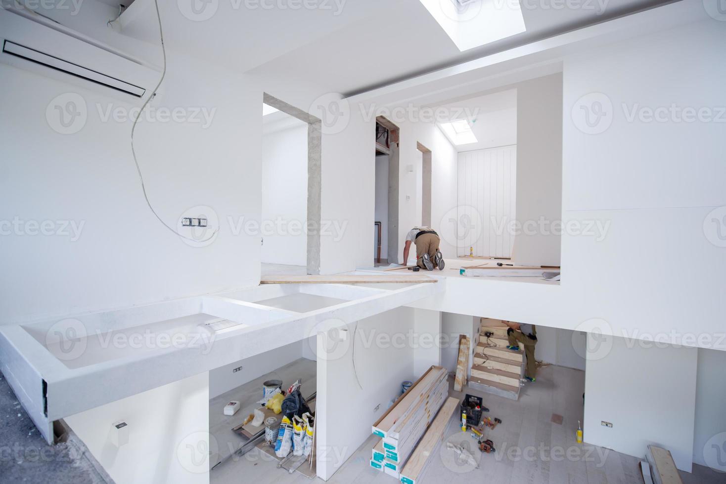 Worker Installing New Laminated Wooden Floor photo