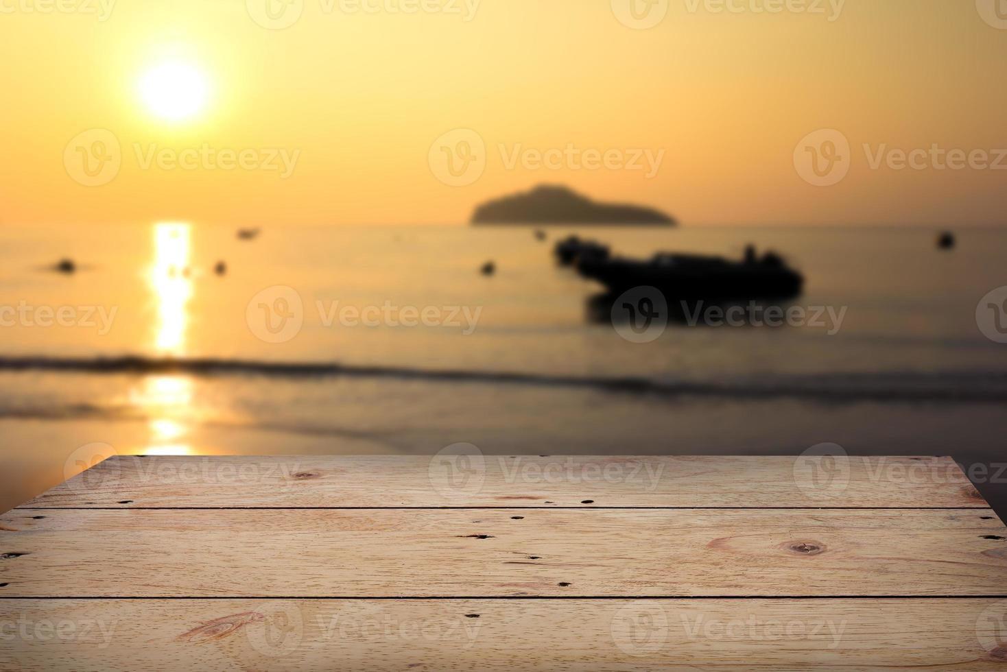 Wooden table with blurry sea view background photo