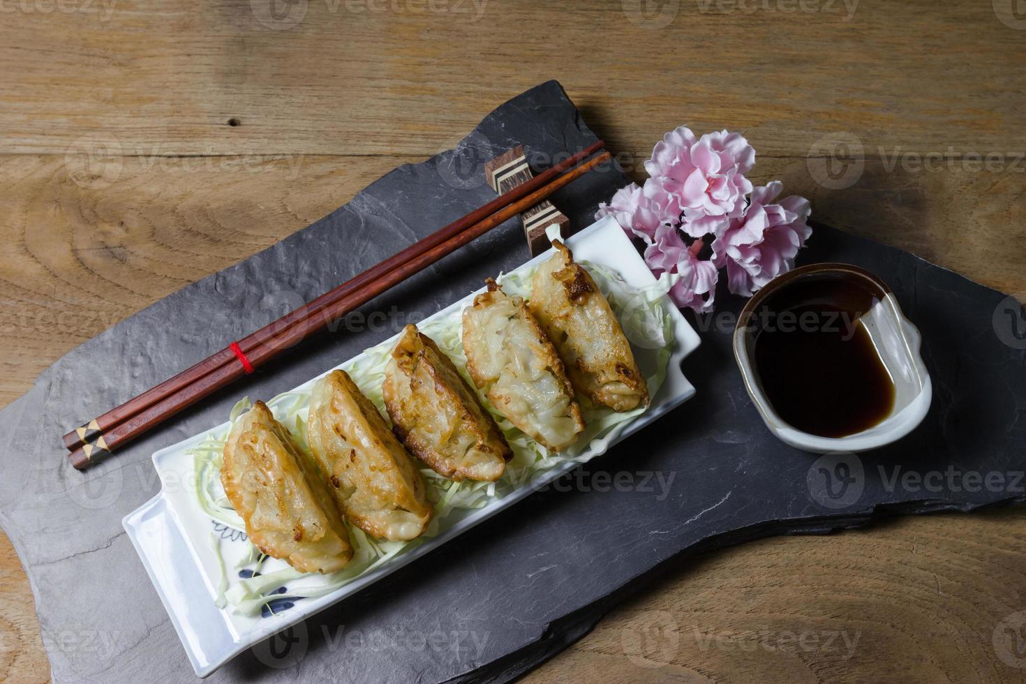 fried dumplings or gyoza on wood background photo