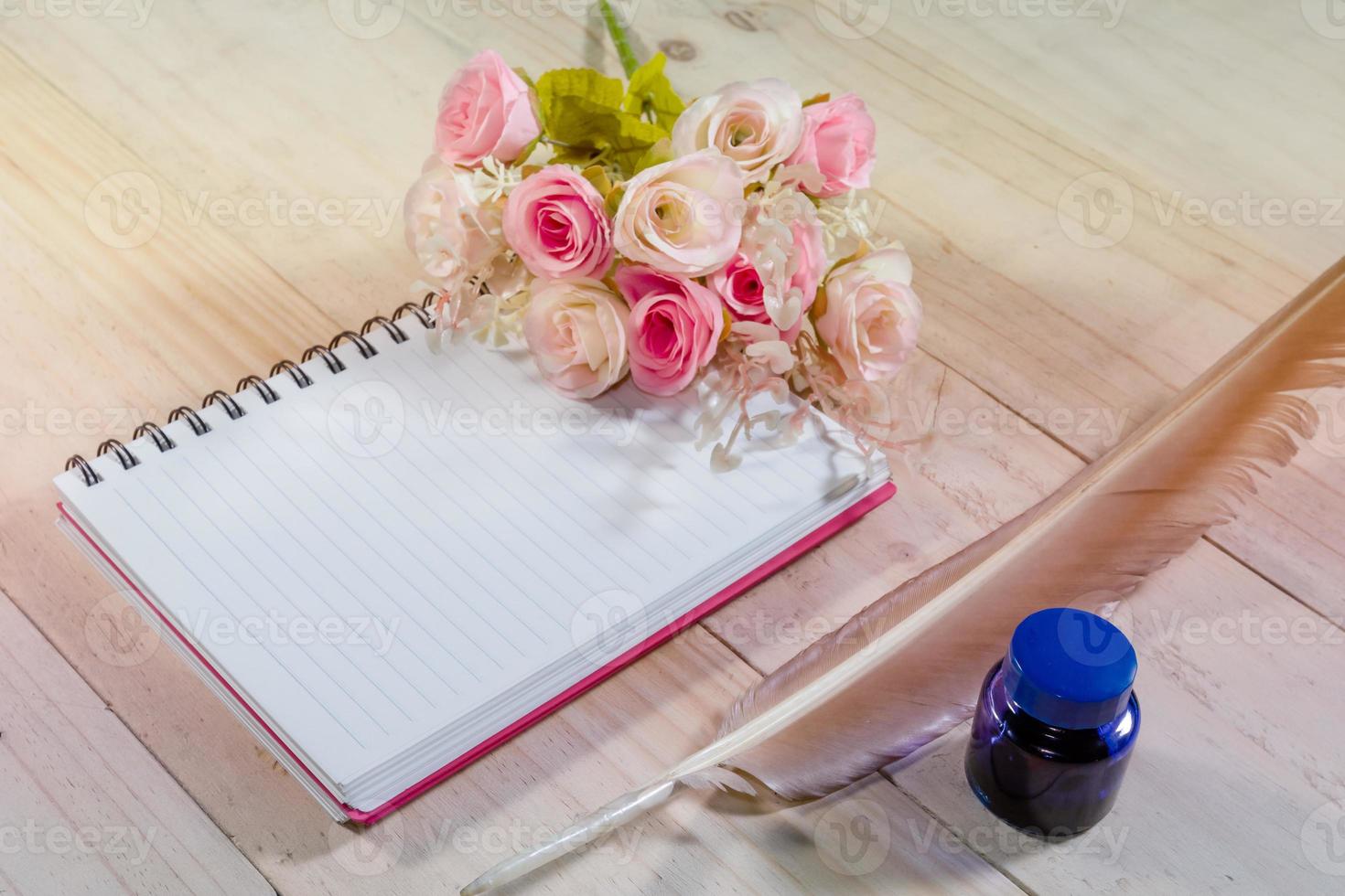 open note book with feather pen,filter effect. photo