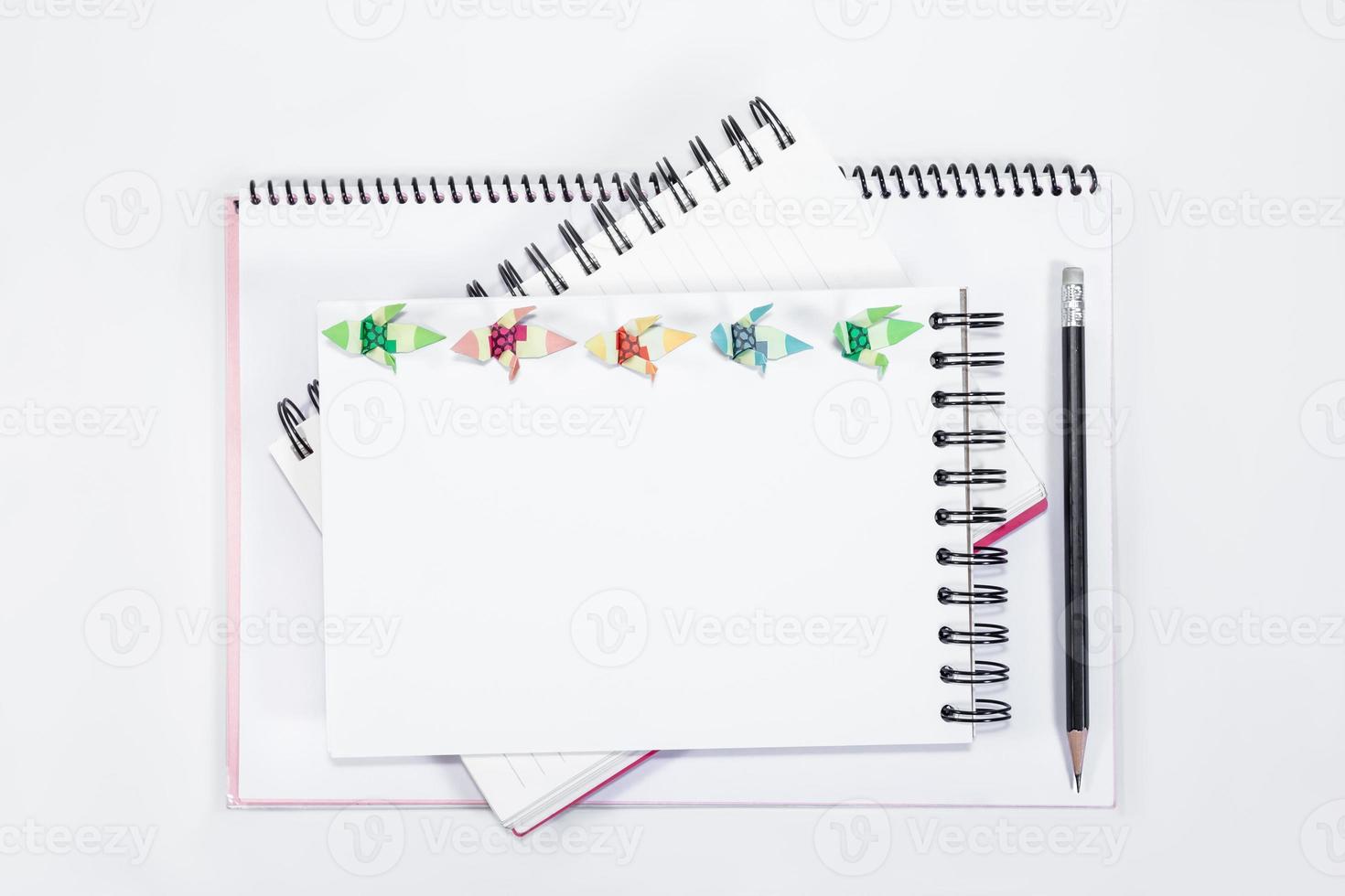 closeup open note book with pencil on background photo