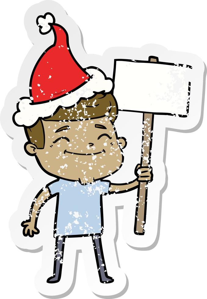 happy distressed sticker cartoon of a man with placard wearing santa hat vector