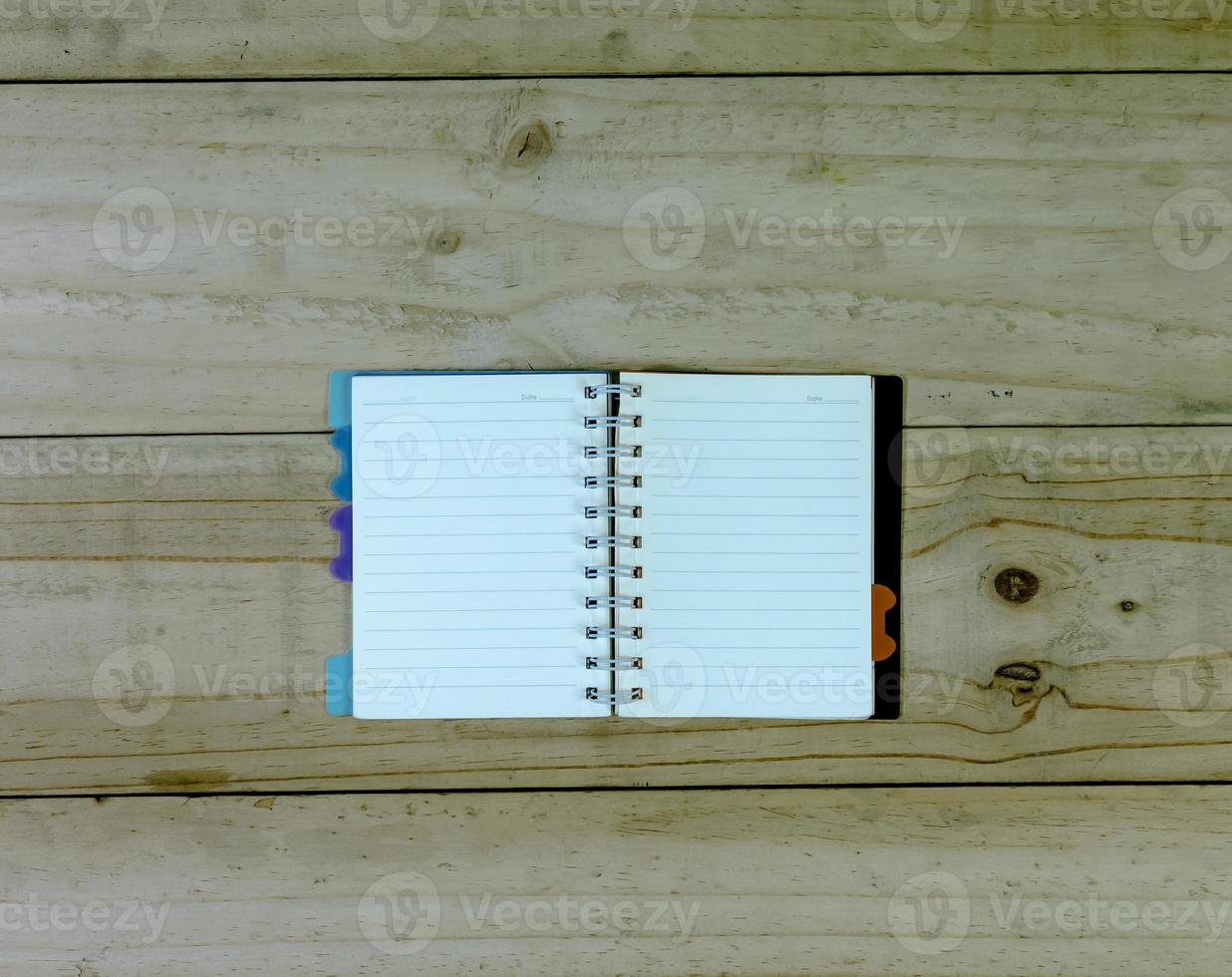 open note book on wooden background photo