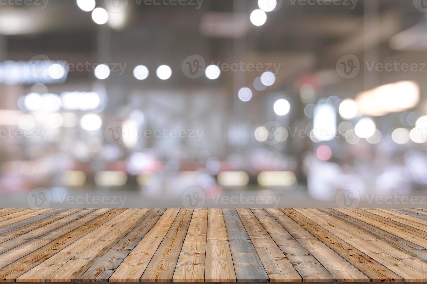 Wooden table with blur restaurant background photo