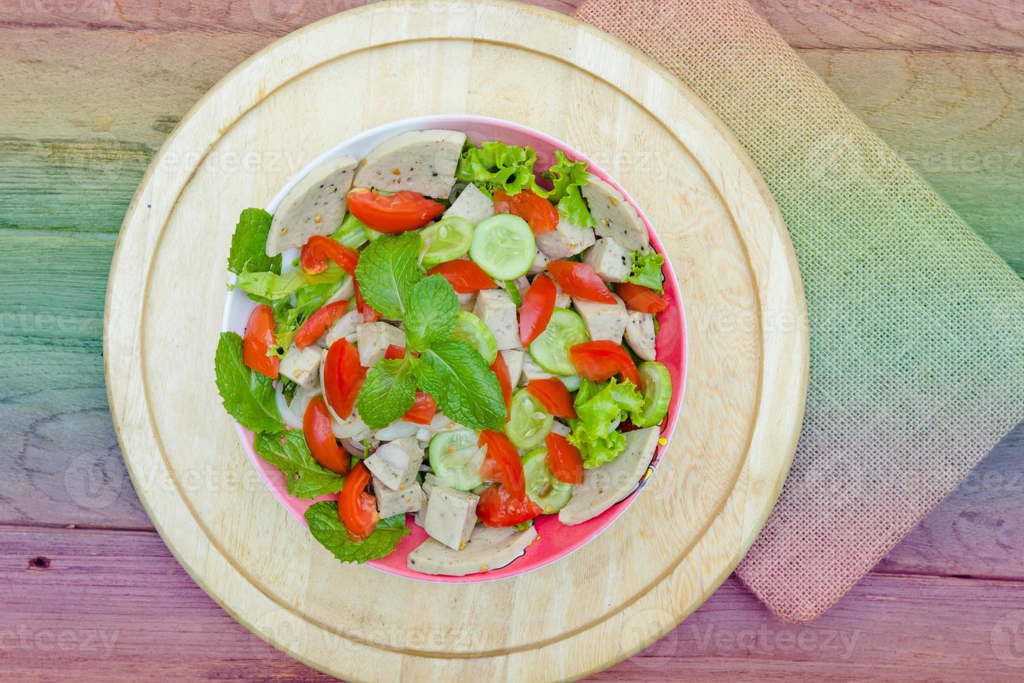 Thai cuisine spicy pork salad on wood background or Yum Moo Yor,filter effect. photo