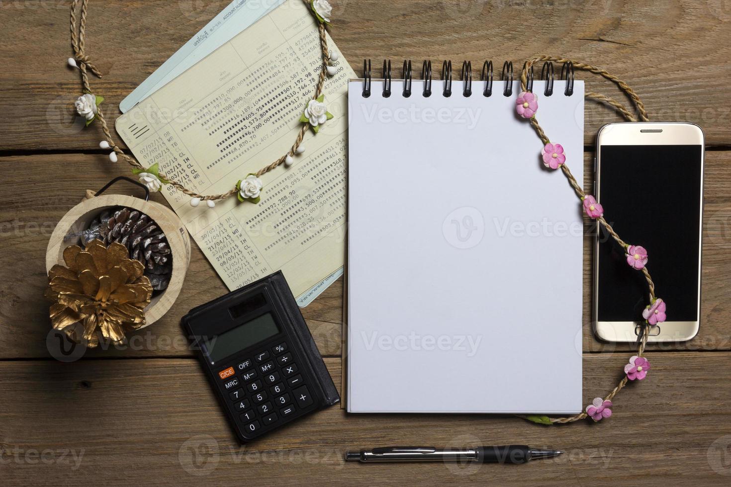 notebook with smartphone and account book on wood background,Business concept photo