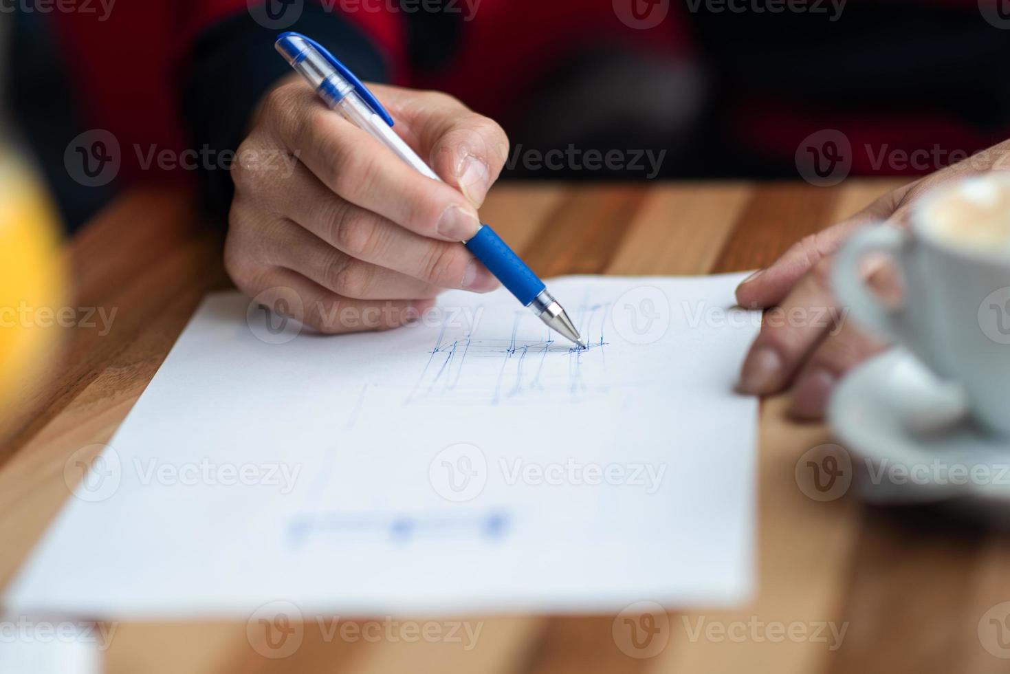 The hand of the designer with a pen sketching his idea photo