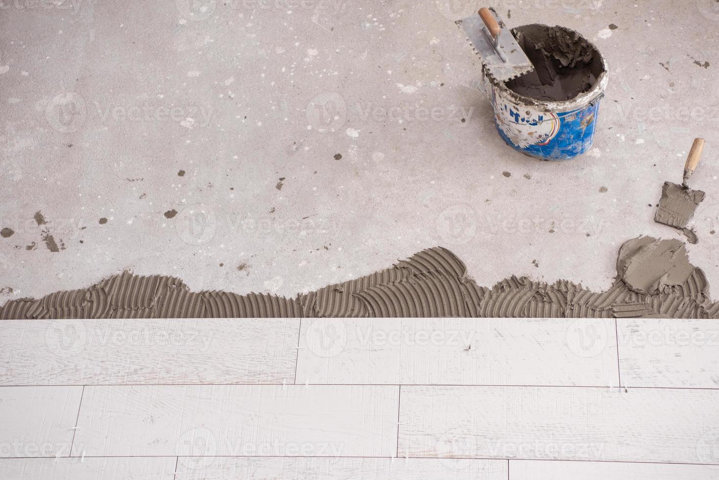 Ceramic wood effect tiles and tools for tiler on the floor photo