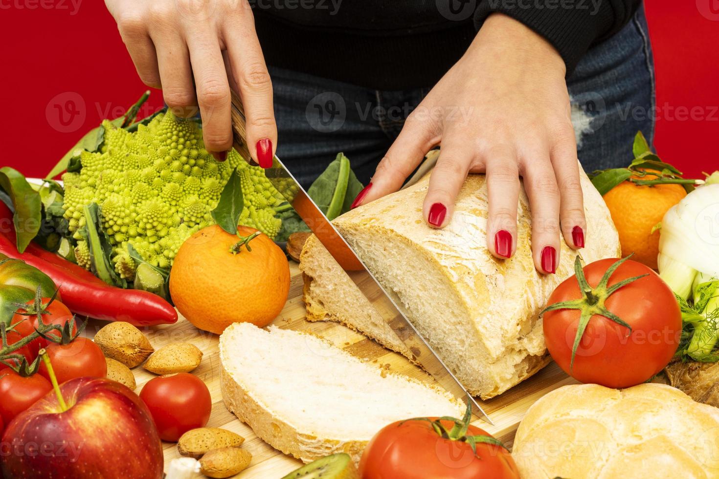 Horizontal shot of female hands cutting some bread photo