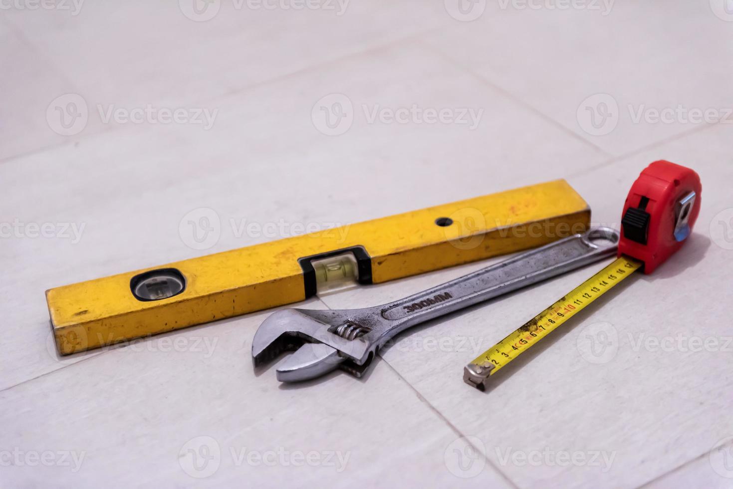 set of hand working tools on ceramic tile background photo