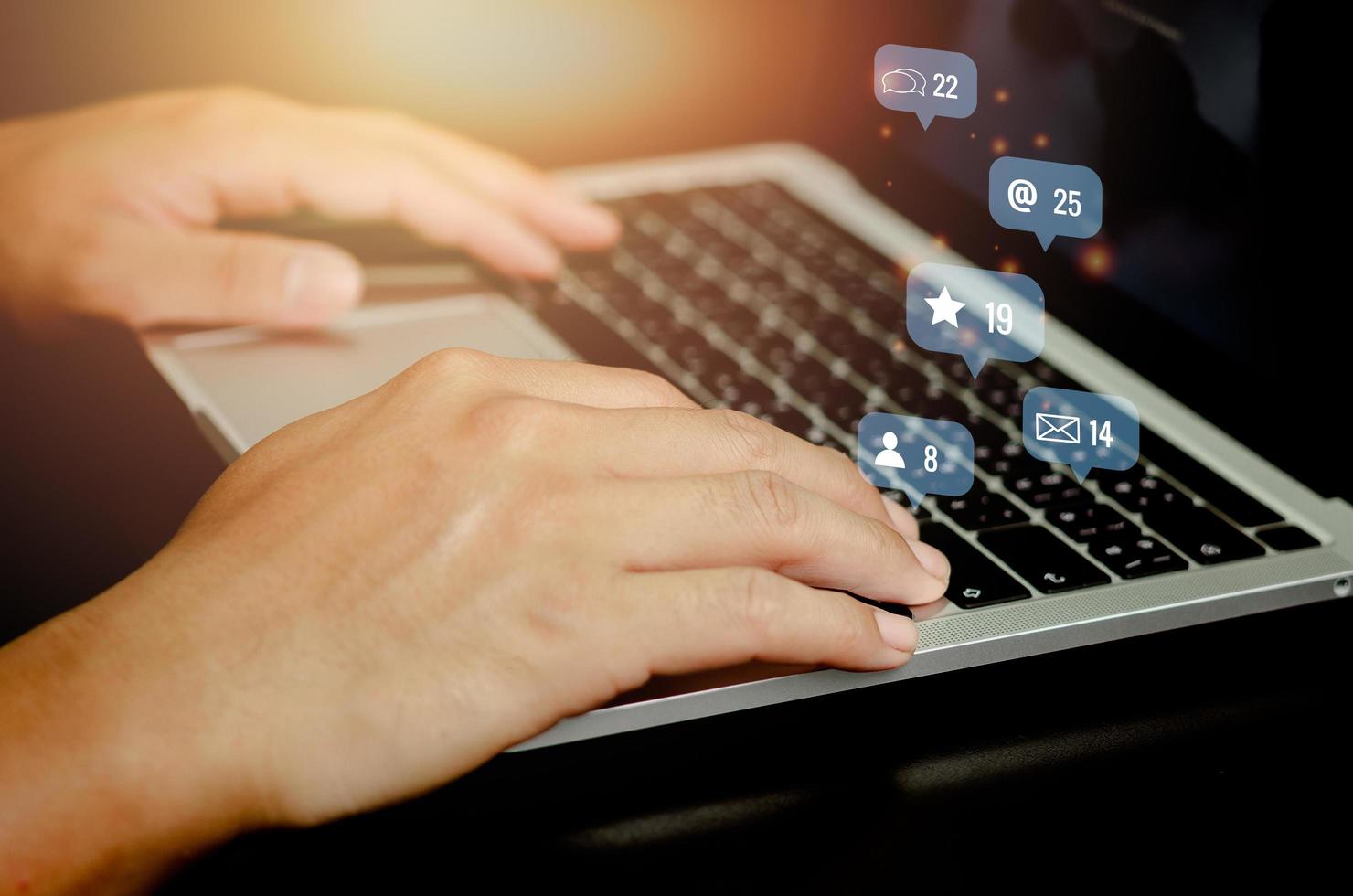 Social media and Marketing virtual icons screen concept.businessman typing keyboard with laptop computer on desk. photo