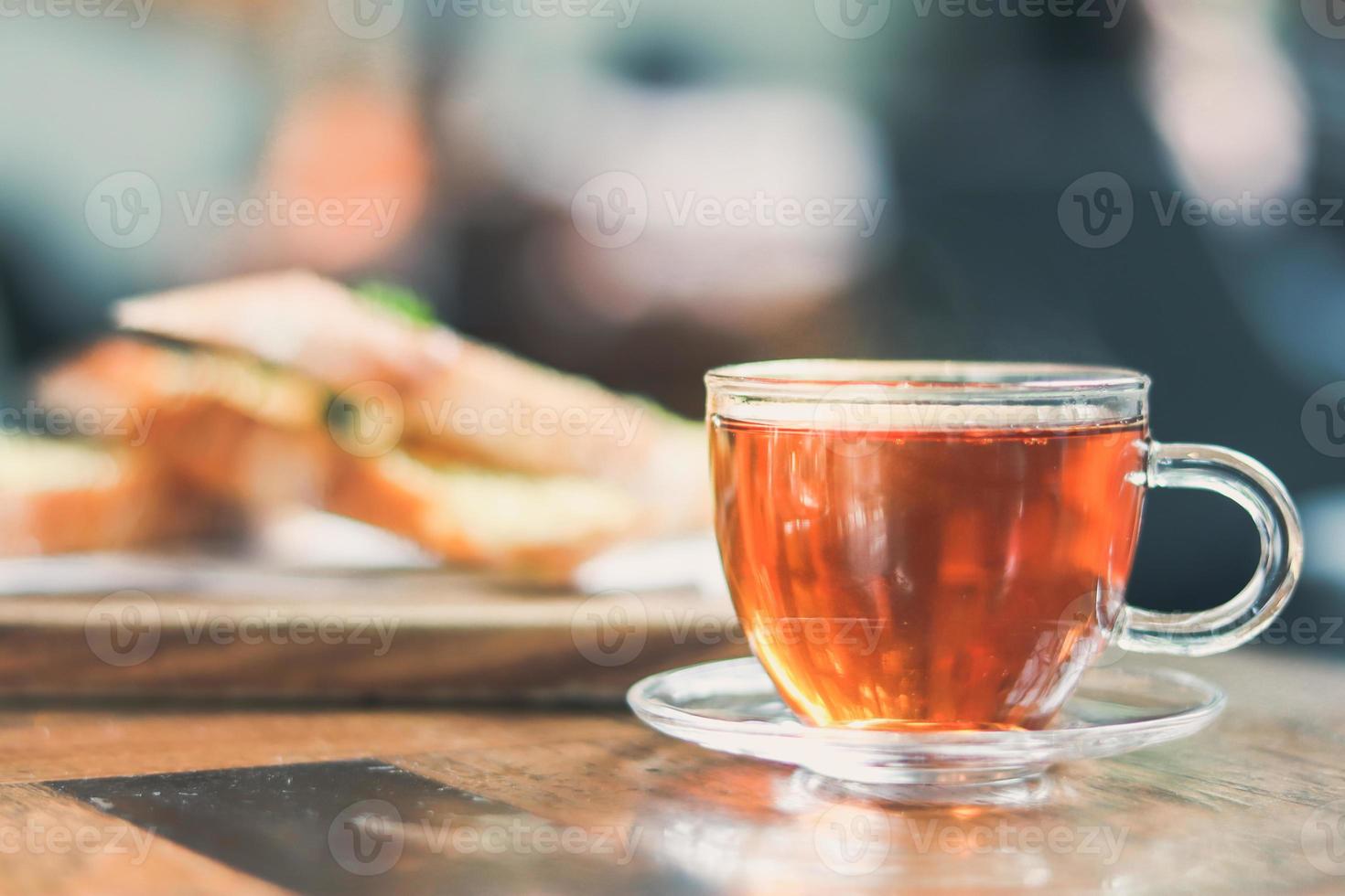 cup of tea at a cafe blurred background and garlic bread. photo