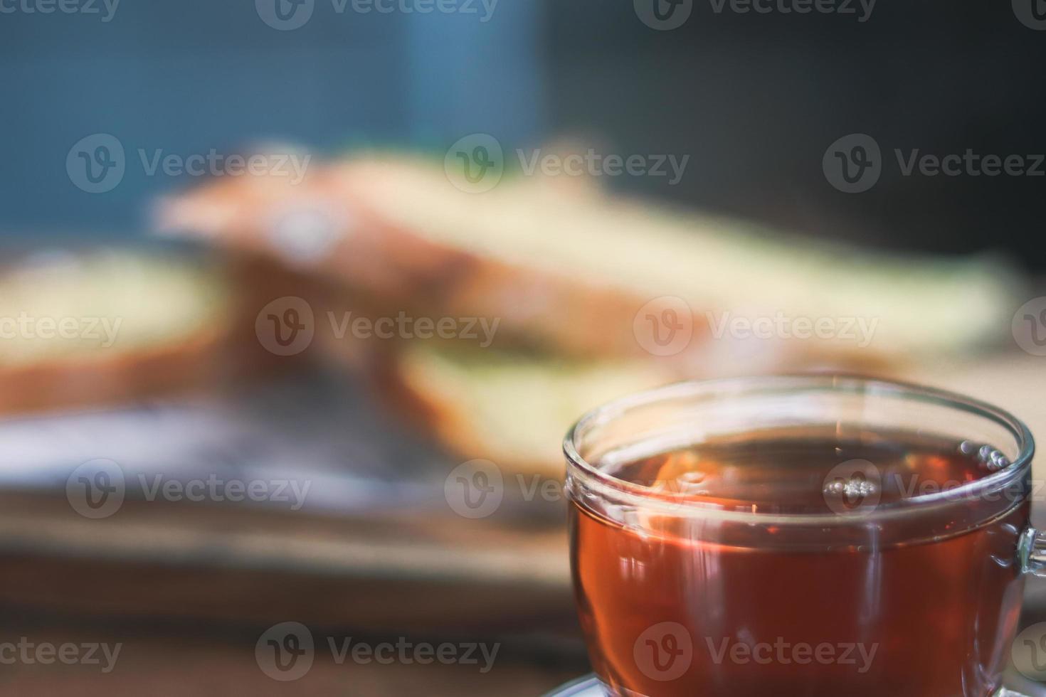 cup of tea at a cafe blurred background and garlic bread. photo