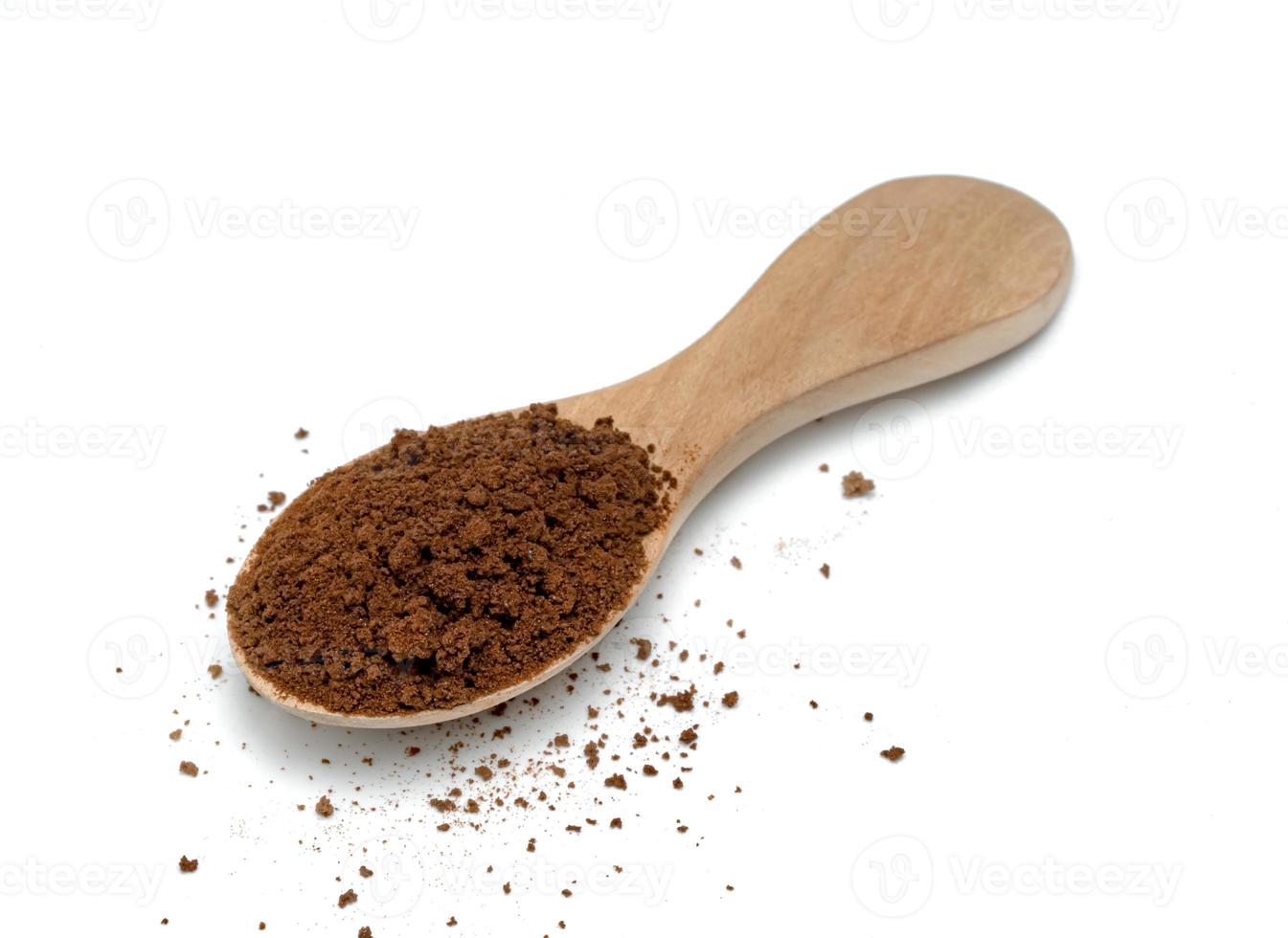 Instant coffee powder with wooden spoon isolated on white background photo