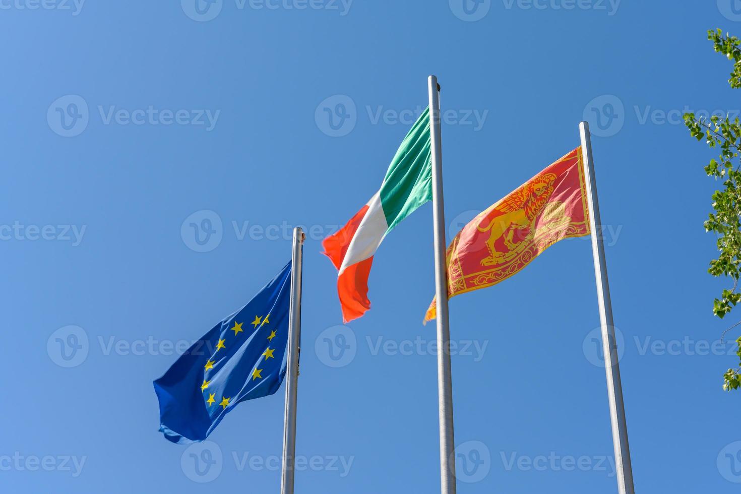 Italian EU and local Veneto flag waving in the wind photo