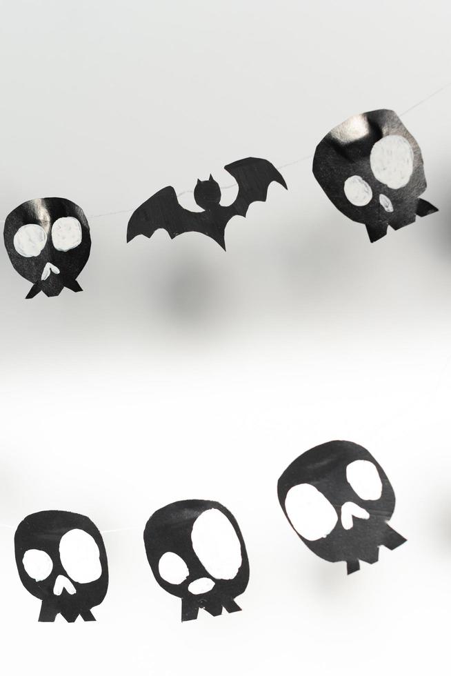 Bats and skulls black on white background, place to write greeting. photo