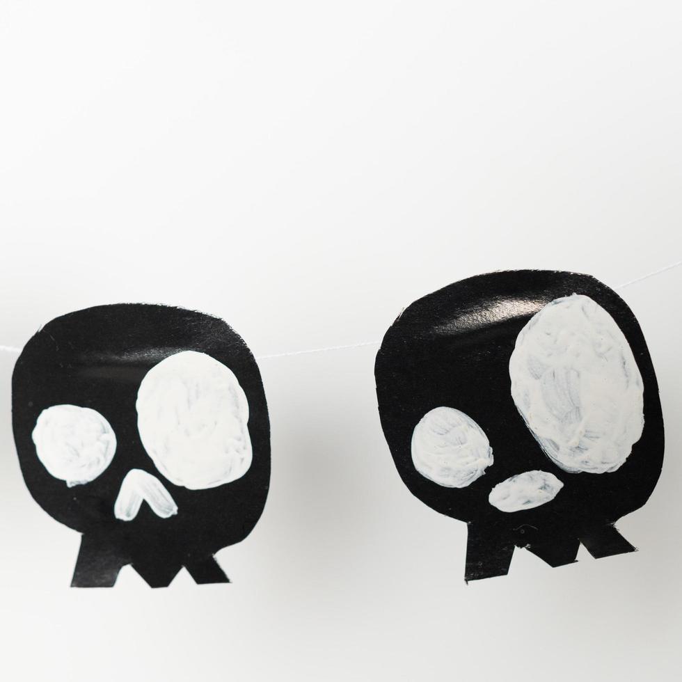 Bats and skulls black on white background, place to write greeting. photo