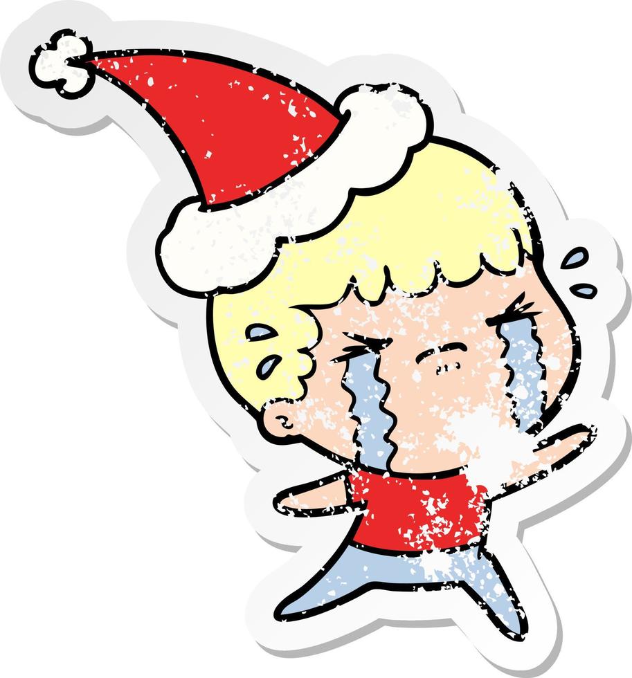 distressed sticker cartoon of a man crying wearing santa hat vector