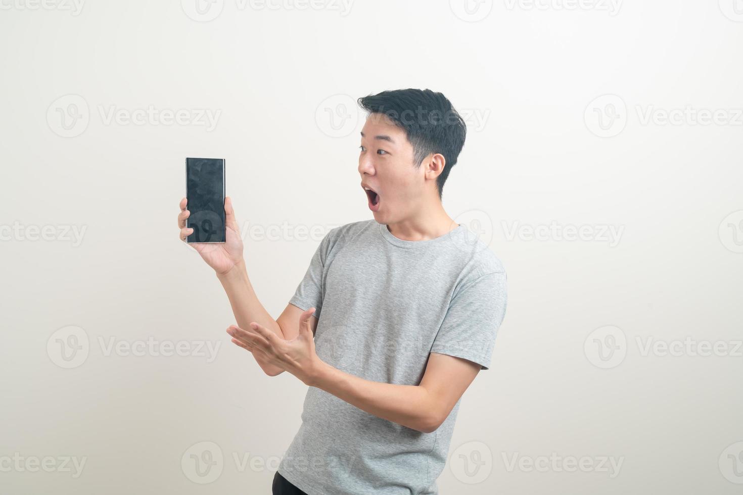 young Asian man using or talking smartphone and mobile phone photo