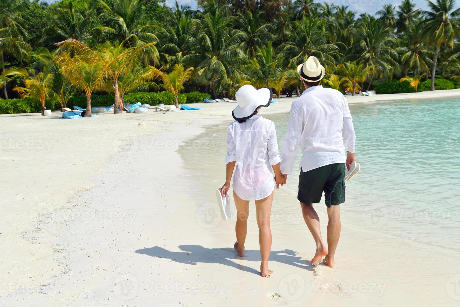 happy young couple have fun on beach photo