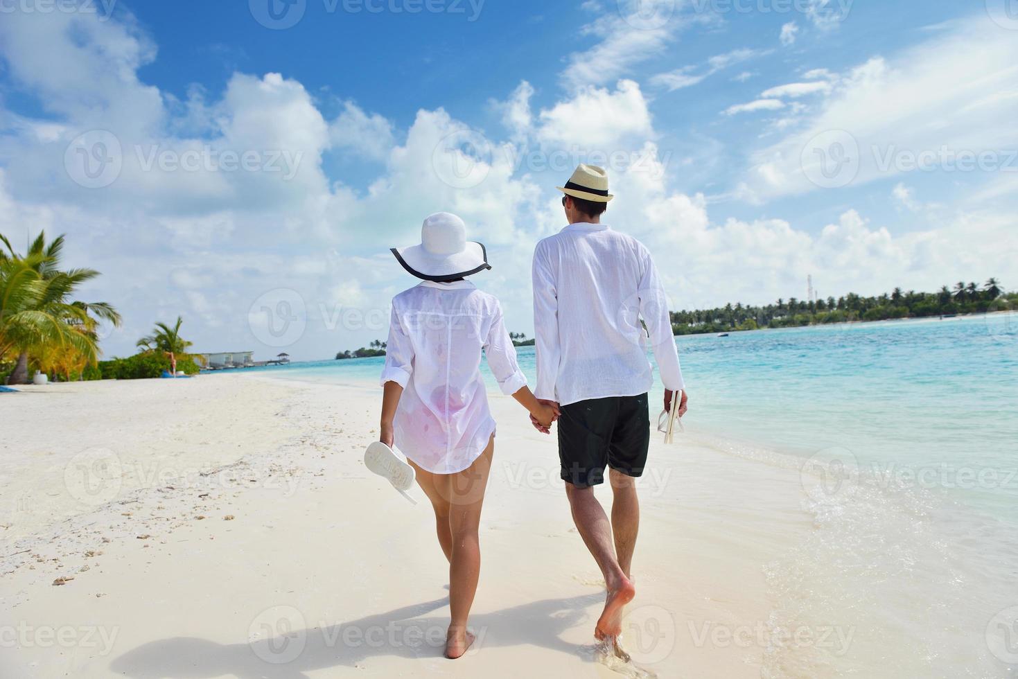 happy young couple have fun on beach photo