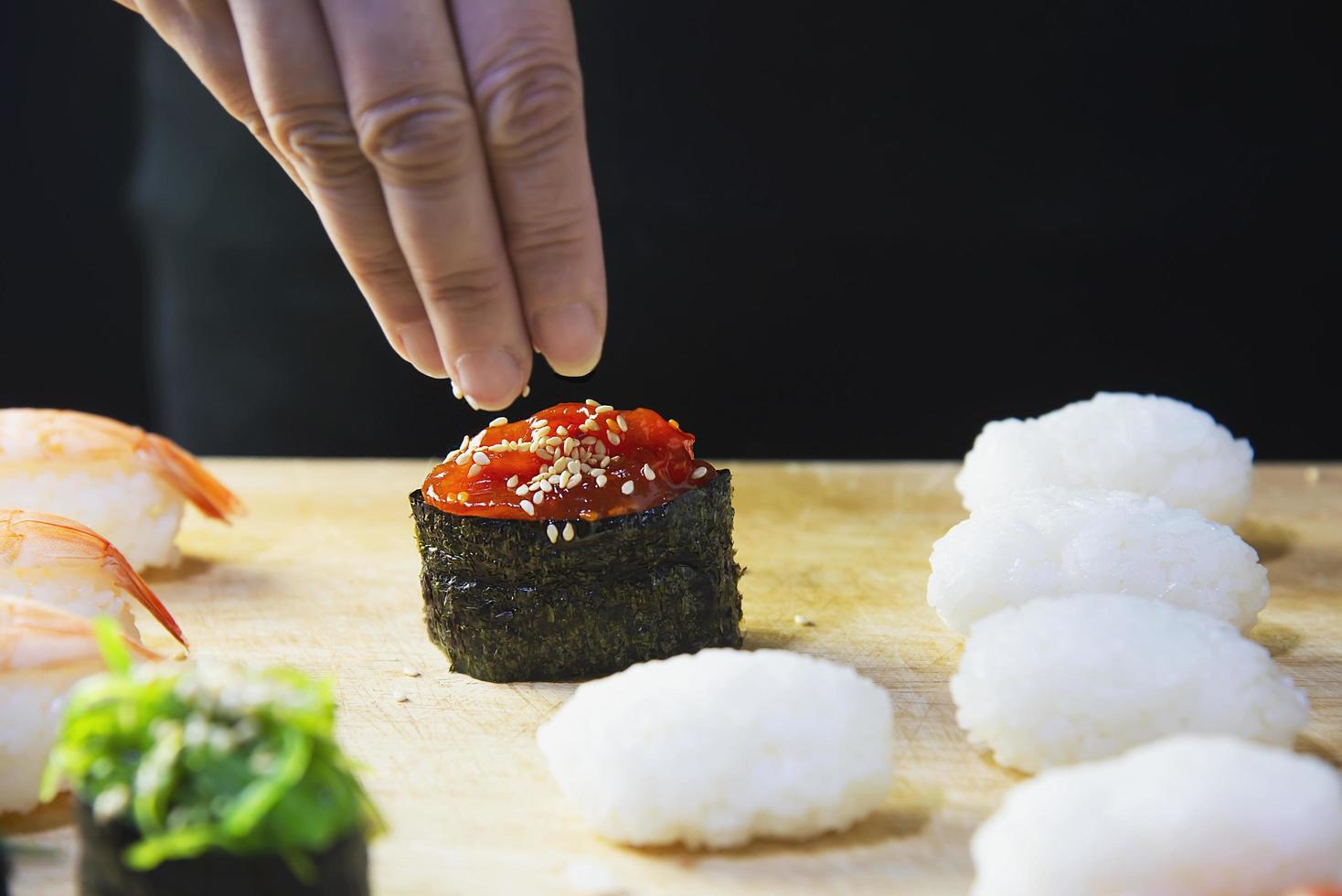 japanese maki sushi roll serving in oriental restaurant, chef is preparing japan tradition cookery menu, various different assorted luxury mixed healthy eating set concept photo