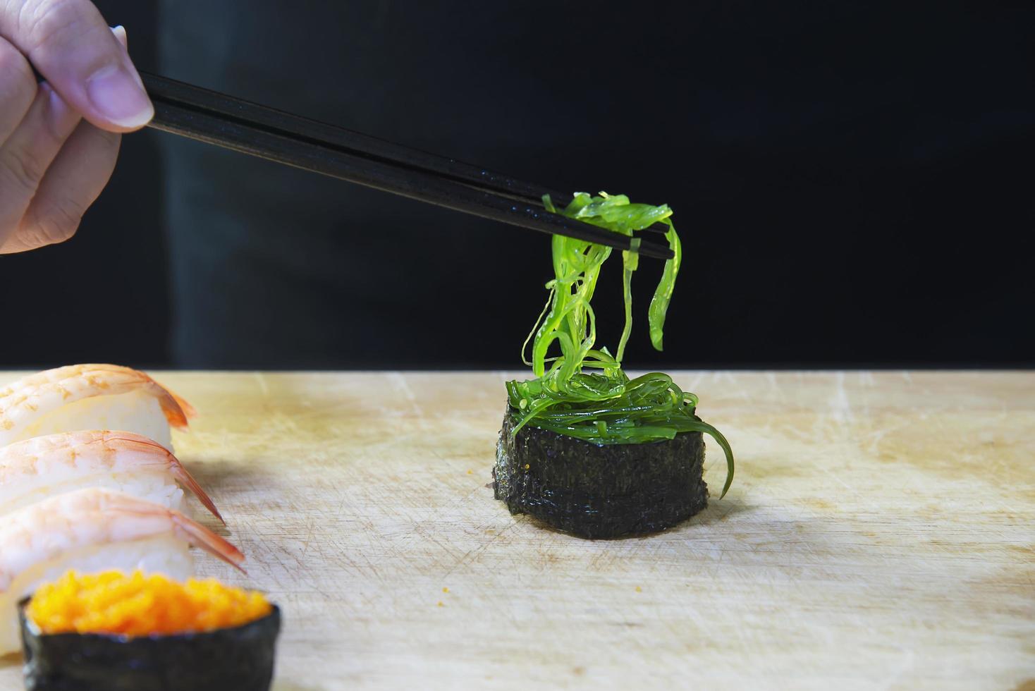 japanese maki sushi roll serving in oriental restaurant, chef is preparing japan tradition cookery menu, various different assorted luxury mixed healthy eating set concept photo