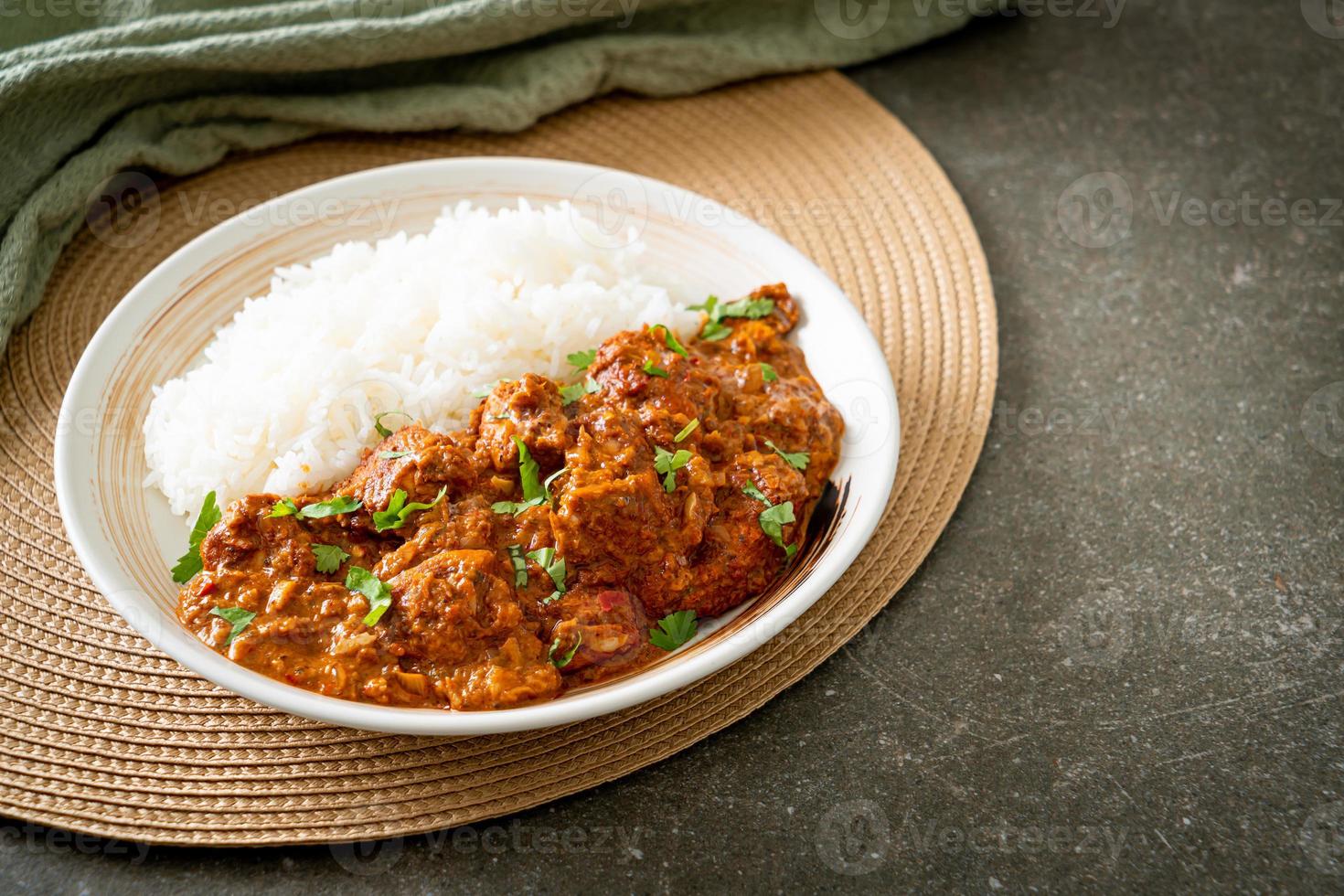 chicken tikka masala with rice on plate photo