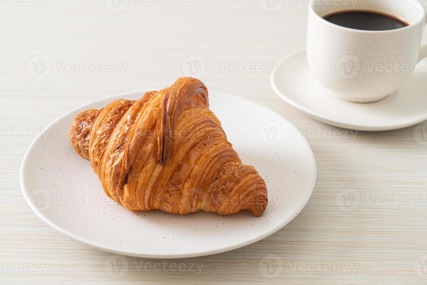 fresh croissant on white plate photo