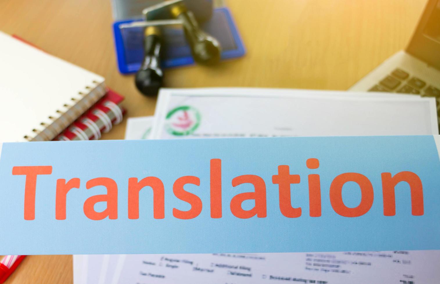 translation word over blur office table photo