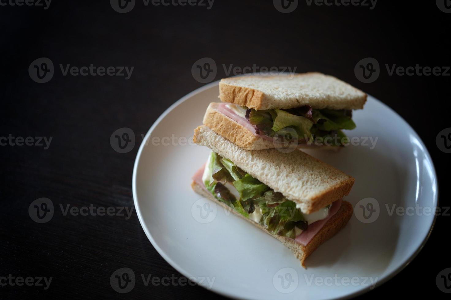 Sandwiches with egg, ham and toast cheese fried in white dish photo